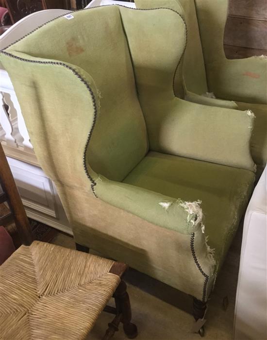 Regency mahogany wing chair raised on turned legs